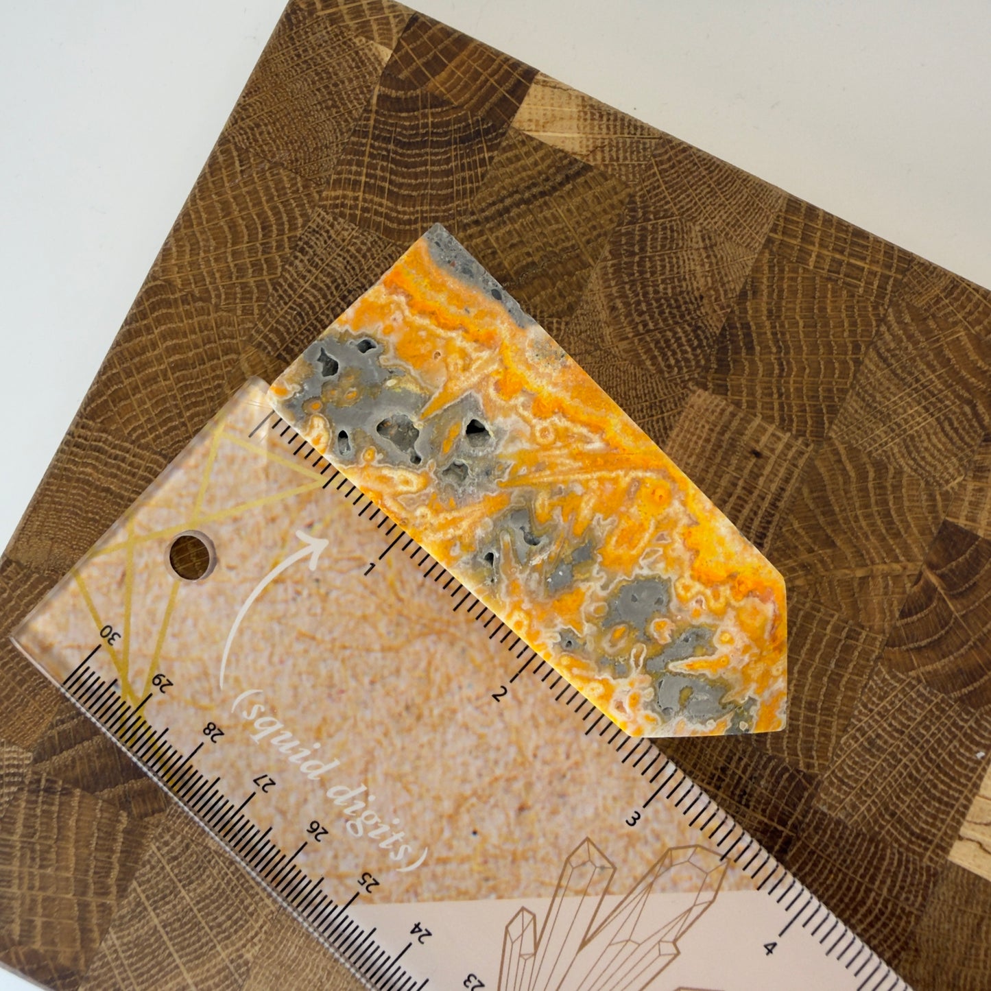 Geode crystal on a patterned surface with a ruler for scale